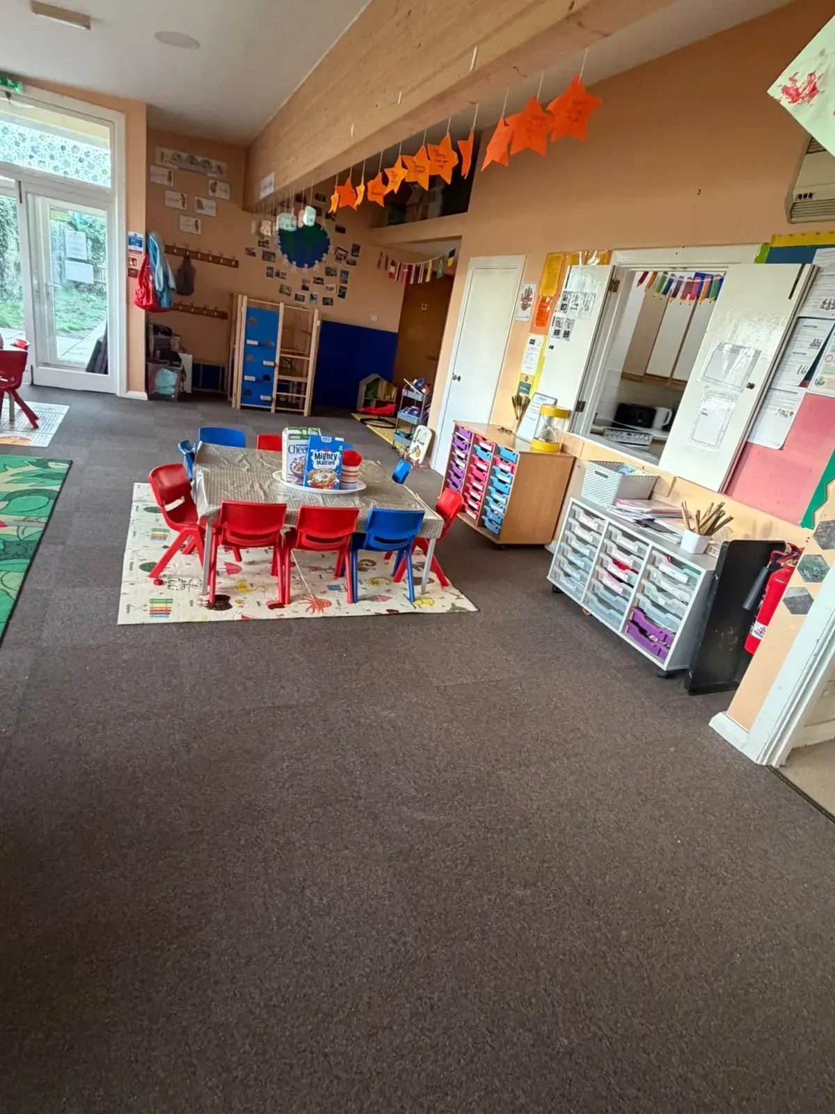Breakfast table set out beside the garden doors in the Ready Steady Go nursery and preschool room in Milton
