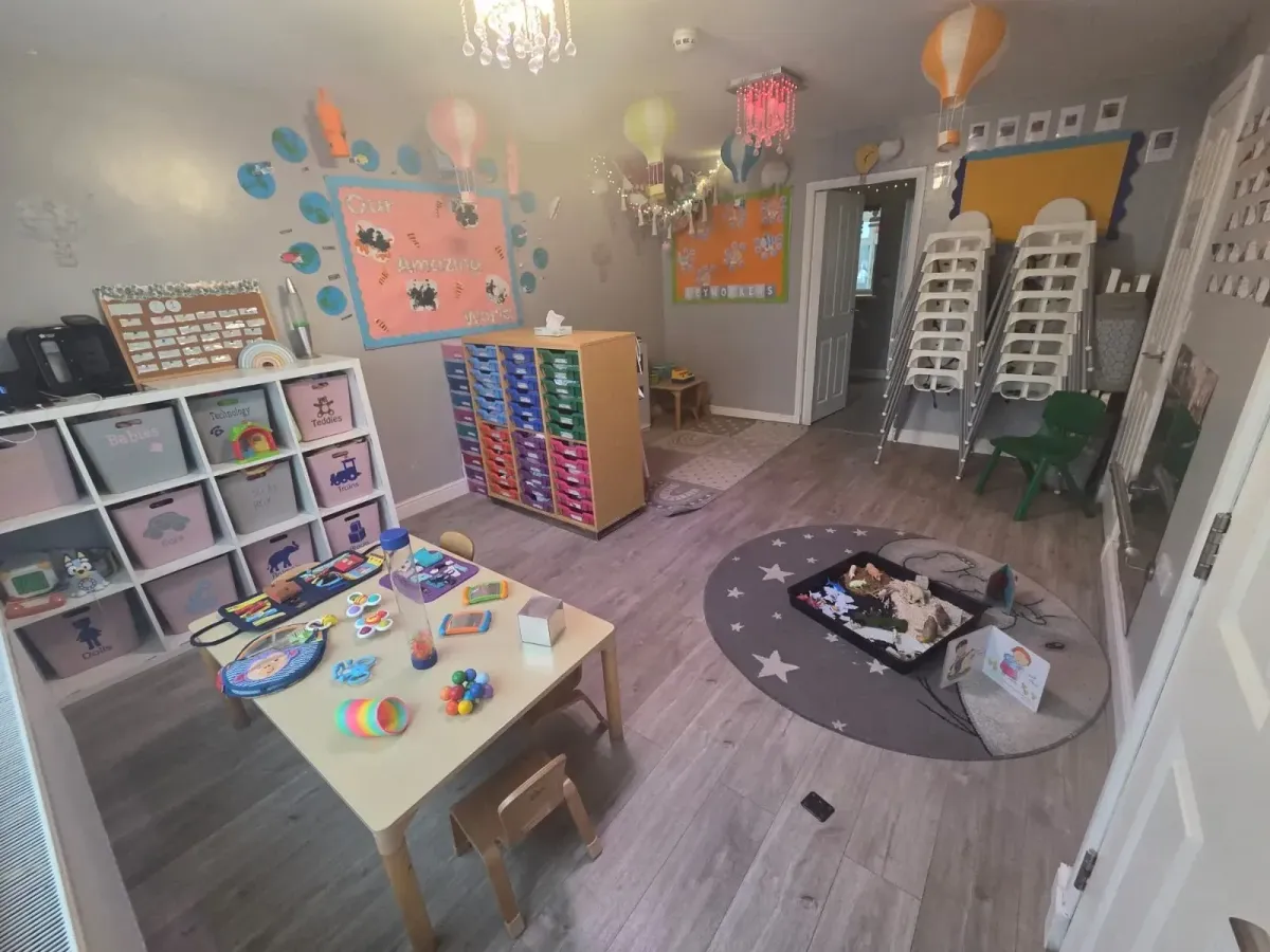 Baby room with sensory toys, storage and a story rug at Ready Steady Go Childcare Worle